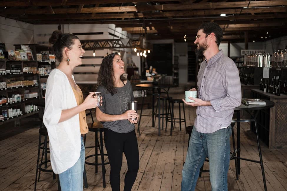 Neighbors sharing a laugh over coffee inside the store
